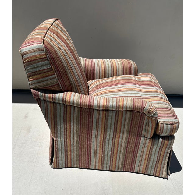Elegant English-style club chair with matching ottoman from the collection of renowned Washington, D.C., interior designer...