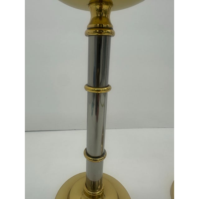 Pair of modernist chrome and brass candlesticks. Both have been professionally polished and lacquered to maintain their...