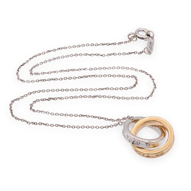 A Tiffany & Co. 1837 Interlocking Circle necklace crafted in sterling silver and 18K rose gold. The design features two...