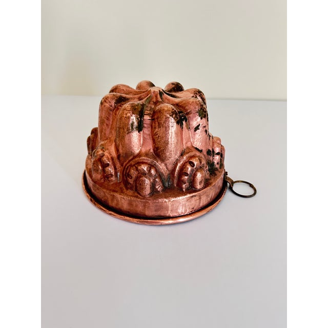 Sourced in the beautiful medieval old town of Rothenburg ob der Tauber, this antique copper Kugelhopf pan has intricate...