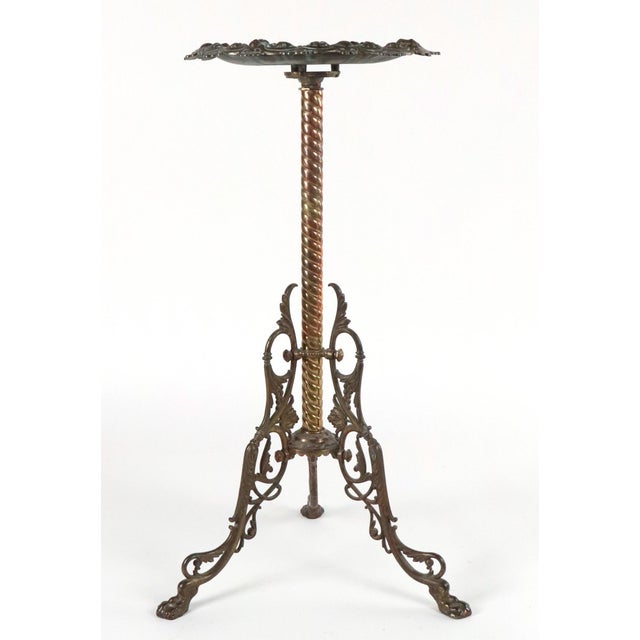 Antique Bradley & Hubbard brass plant stand in a Victorian style, with the telltale scalloped and embossed top supported...