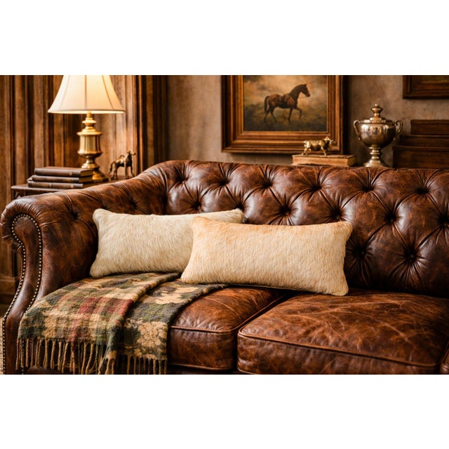A striking pair of rustic accent pillows crafted from natural cowhide, these custom-made pieces beautifully capture the...