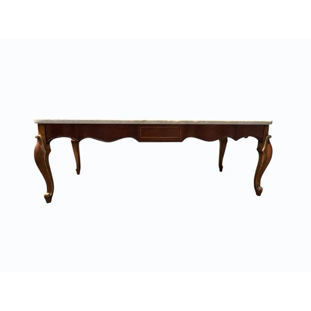 This Louis XV-style French Provincial coffee table features a solid cherrywood base with hand-applied gold leaf accents,...