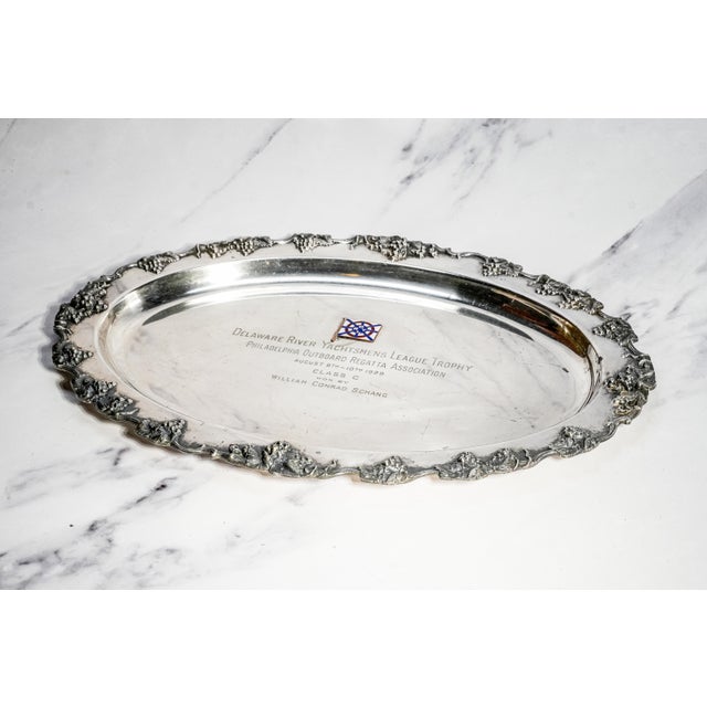 A striking blend of nautical history and decorative craftsmanship, this antique silverplate presentation tray possesses...