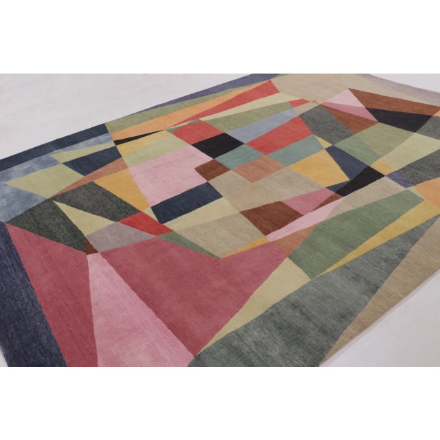 This 9 x 12 modern rug from India presents a bold exploration of mid-century modern abstraction through a vibrant...