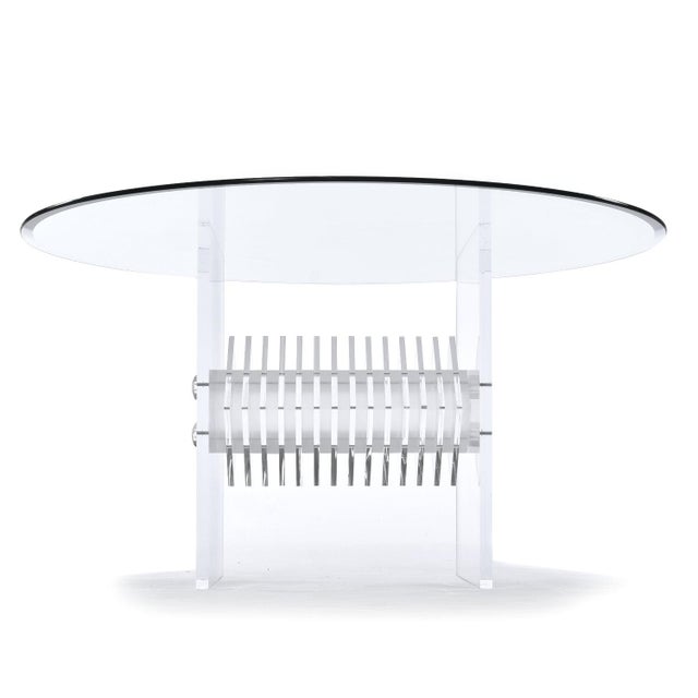 This listing is for the table alone. The chairs are sold separately. Post Modern clear acrylic pedestal dining table with...