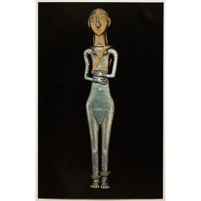 A rare gold foil photogravure (print) of Silver Statuette Of A Nude Goddess. Gold foil overlay on the head, gold breasts,...