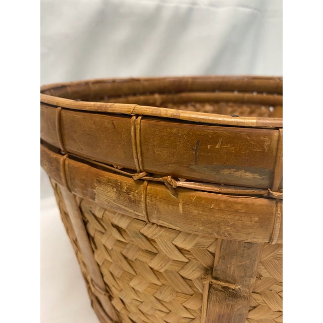 A substantial vintage splint handwoven wicker basket with beautiful natural patina and sturdy construction. This large...