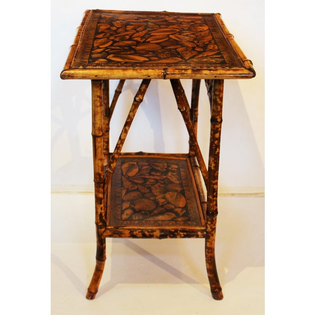 Circa 1880 2-tier rectangular bamboo table, English. The original surfaces now artisan decoupaged with shells. Arch...