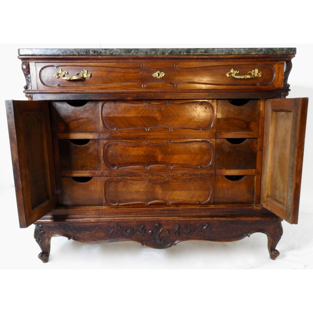 A scalloped apron graces the front of this French linen press featuring a black granite top. One drawer on the top level...