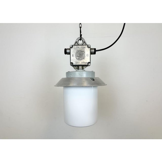 This Industrial hanging light was made by Elektrosvit in former Czechoslovakia during the 1970s. It features a cast...