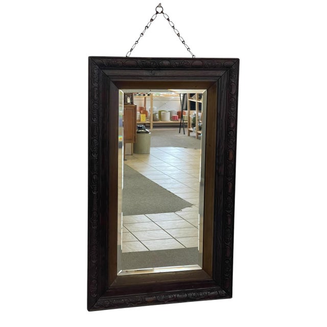 Victorian 1890s UK import wall mirror featuring a solid oak frame with an intricately carved repeating floral and scroll...