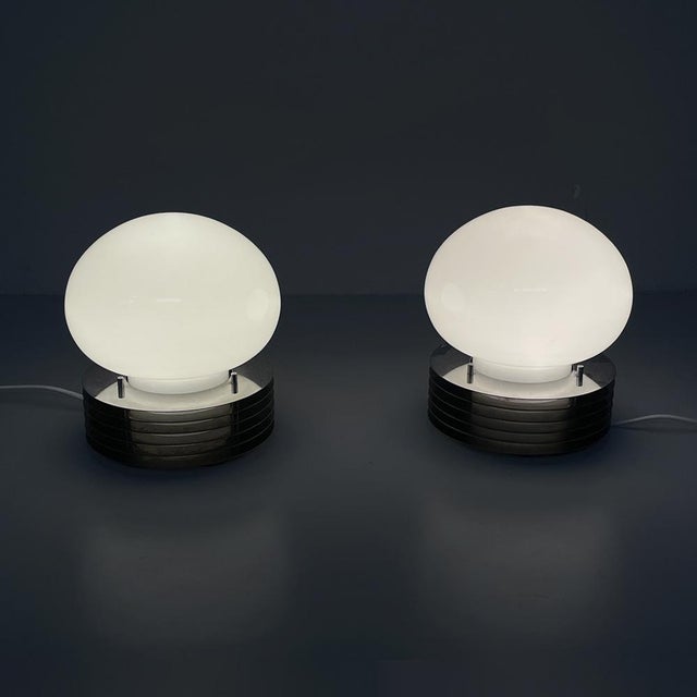 Italian modern table lamps in steel and opaline glass by Tronconi, 1970s Pair of table lamps with a base composed of...