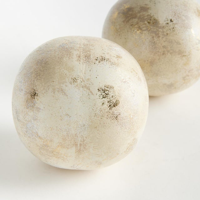 Hand painted, and handappliedGold leafing makes these decorative orbs special. Made out of iron, these substantial orbs...
