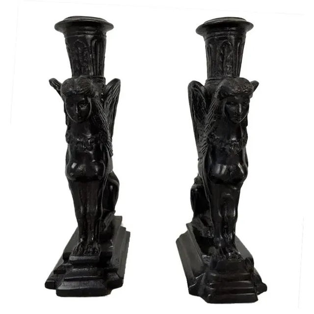 A chic vintage pair of Art-Deco Sphinx candleholders cast in solid black bronze embodying European high-style and...
