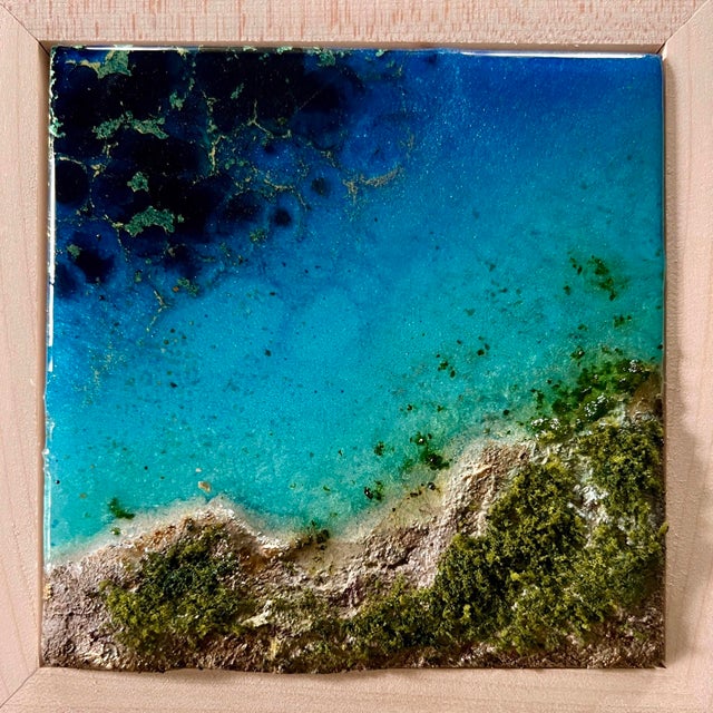 This artwork captures an aerial view of a vibrant ocean, where layered tinted resin creates a dynamic interplay of deep...