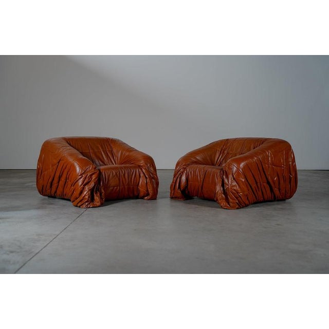 Piumino lounge chairs. The chairs are in good condition with some traces of usage normal to their age. w 104 x d 106 x h...