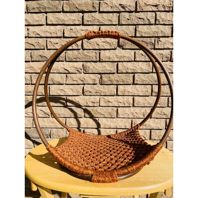 Vintage 1970s mid century modern macrame style woven open concept magazine rack. Wood base with multi colored woven base...