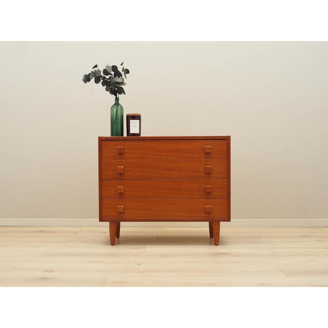 The chest of drawers was made in the 1970s in Denmark. The structure is covered with teak veneer. The legs are made of...