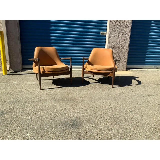 Pair of mid century lounge chairs The chairs are done in a leather The frames are solid walnut The chairs are in excellent...