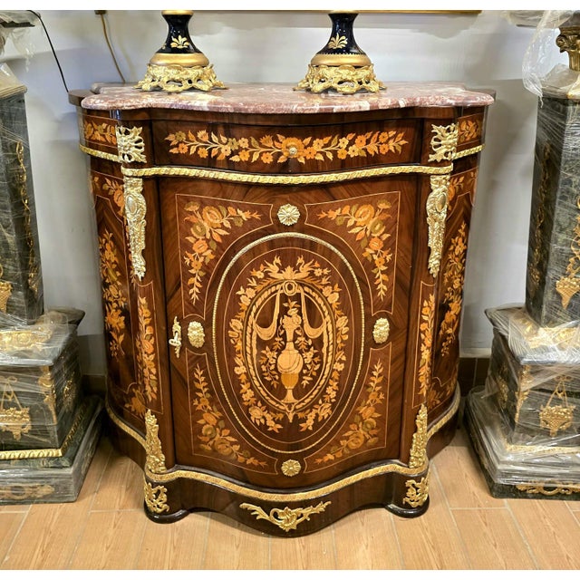 Elevate your interior with this stunning French-style marquetry cabinet, masterfully crafted with intricate floral inlay...