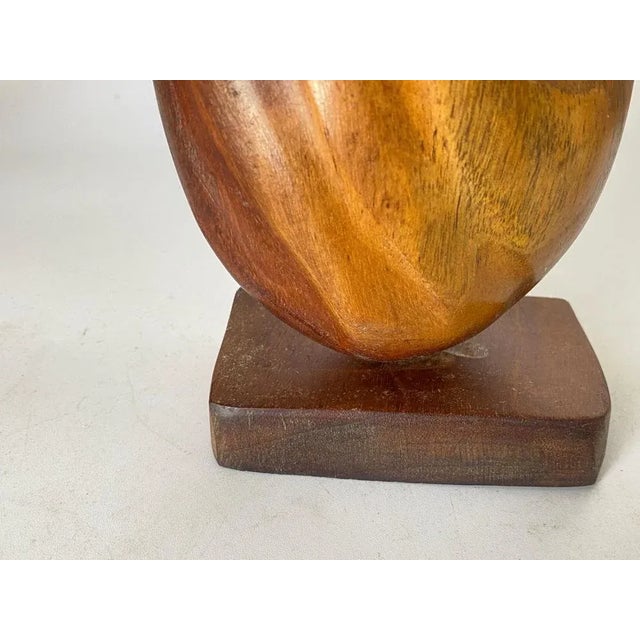 This sculpture is in wood, in brown color. The shape in at the same time, abstract, in the style of Alexandre Noll It has...