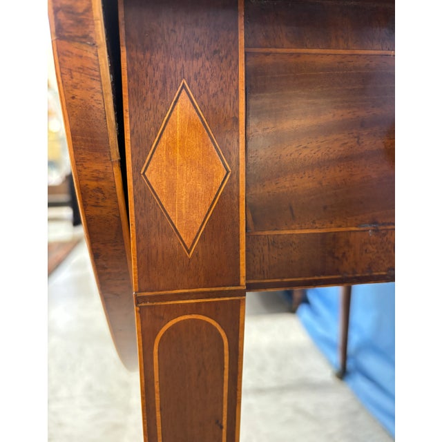 A superb 18th century Georgian Mahogany Pembroke Table with Satinwood banding and detailing along the square tapered legs....