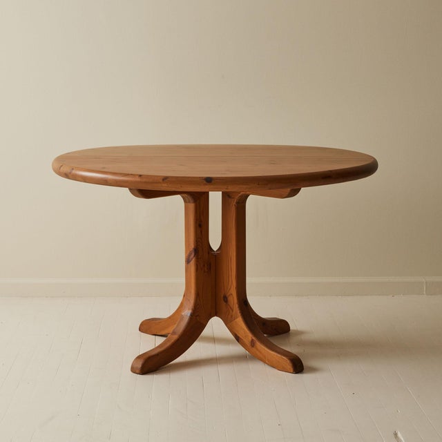 Danish designer Rainer Daumiller, round pine dining table, mid-20th century. Featuring softly rounded edges for an...
