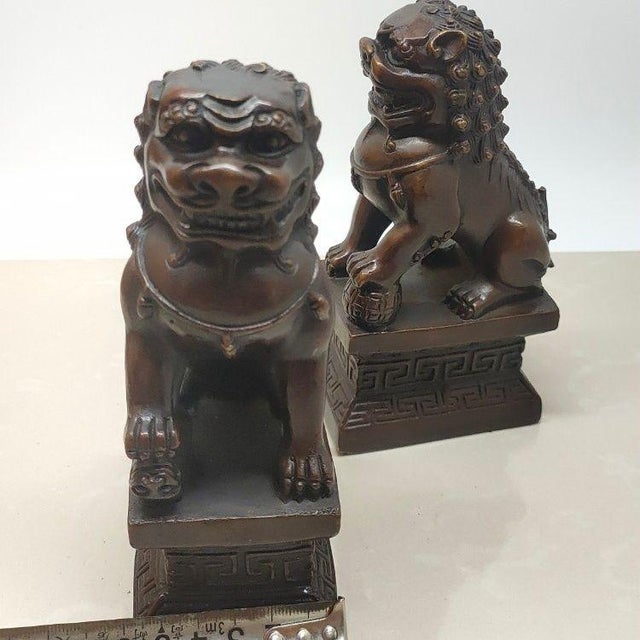 This is a handsome pair of vintage Chinese bronze guardian lions, also known as Foo Dogs or Shishi. Each lion is seated on...