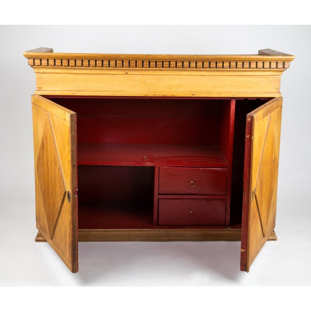 19th Century Gustavian Swedish wall cabinet with dentil molding along the crosshead and carved fluted diamonds on the...