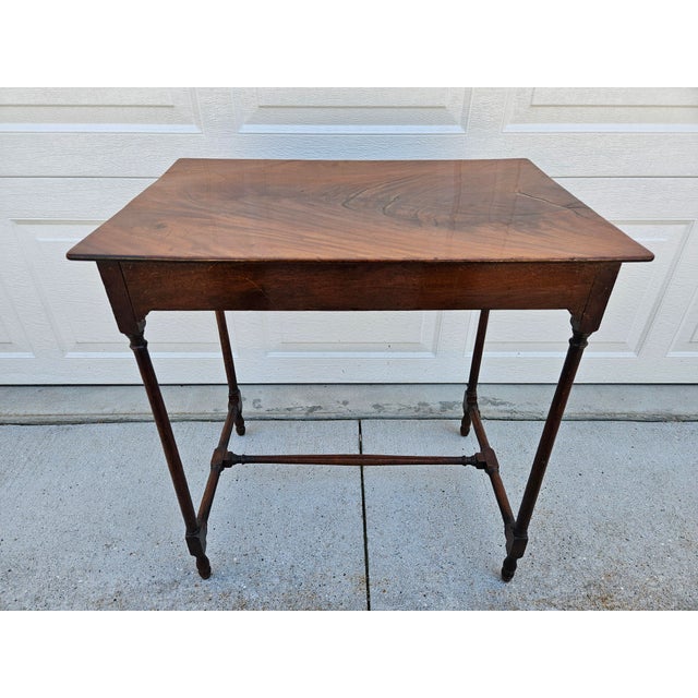 This antique Georgian style mahogany spider leg side table, features a rectangular top and slender, turned legs joined by...