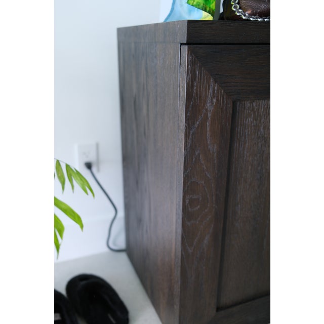 The Restoration Hardware Machinto 4-Door Media Console in Grey Oak with Burnished Brass pulls, designed by the Van Thiels,...