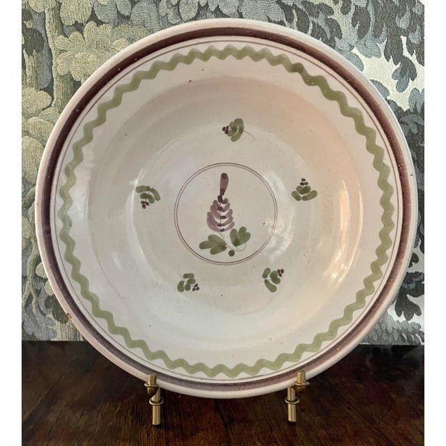 A lovely pair of faience plates with complementary purple, green, and yellow color schemes. With minor wear at edges and...