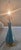 A stunning turquoise and gold Mid-Century porcelain lamp. This lamp is 25" tall, 6" wide. The surface features a varied,...