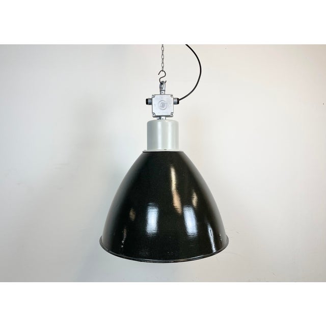 Industrial enamel pendant lamp designed and produced by Elektrosvit in former Czechoslovakia during the 1960s. It features...
