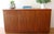 This is a mid century modern teak sideboard credenza that has a beautiful wood grain outside and in, 3 dovetailed drawers...