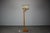 A refined Mid Century wooden floor lamp produced in Europe during the 1960s. The lamp features a sculptural bentwood...