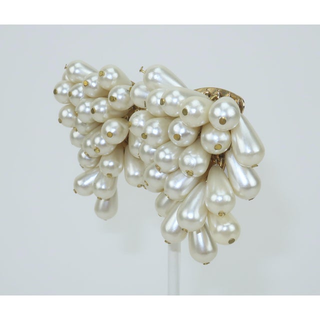 Faux faboo! 1980's faux pearl cluster clip-on earrings with gold tone metal hardware. The earrings resemble a fabulous...