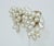 Faux faboo! 1980's faux pearl cluster clip-on earrings with gold tone metal hardware. The earrings resemble a fabulous...