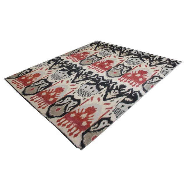 A beautiful handmade Ikat rug. It's floral design woven in by Aara Rug hands. This rug is made of 75% wool and 25% cotton....