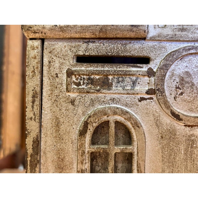 This antique cast iron Home Savings Bank, originating from Detroit, Michigan, is a wonderful example of early 20th-century...