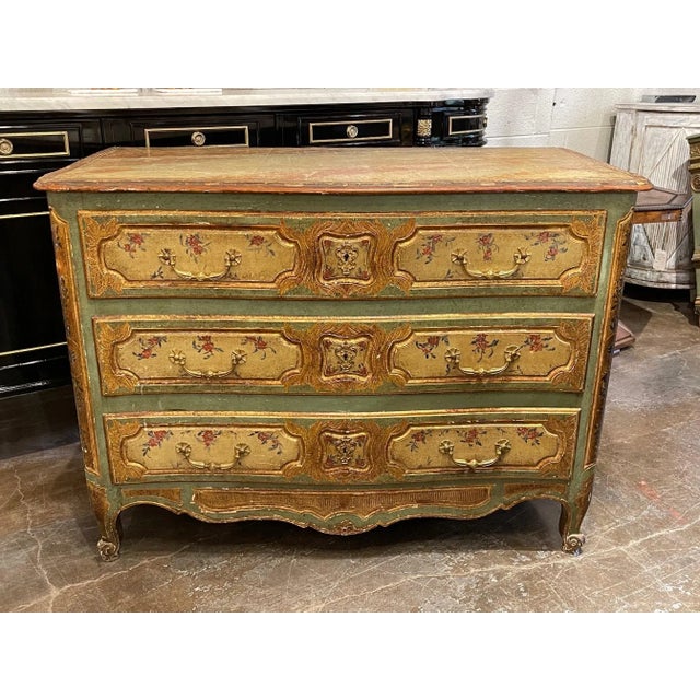 Lovely early 19th century French Louis XV style painted commode. Featuring beautiful floral images and the colors of gold,...
