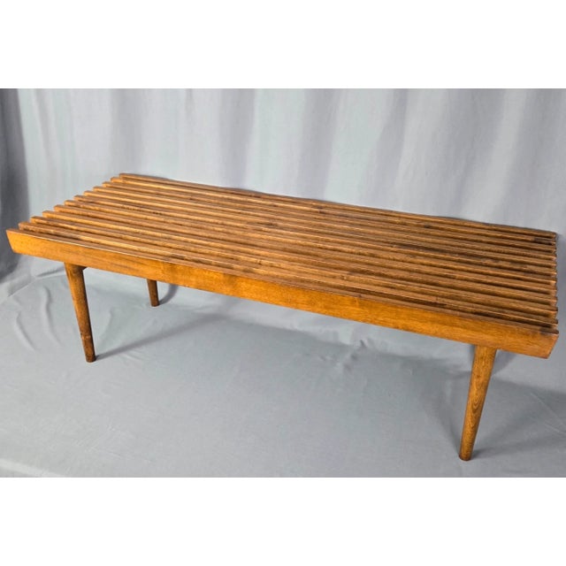 Solid Walnut and very nicely made. Classic slatted form with tapered legs, practical 4-foot size. Fine quality, excellent...