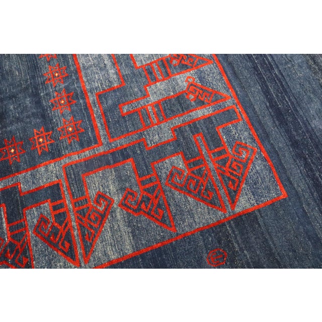 One of a kind 21st century oversize Persian rug with an open field solid design in blue and red. 100% vegetable dyed....