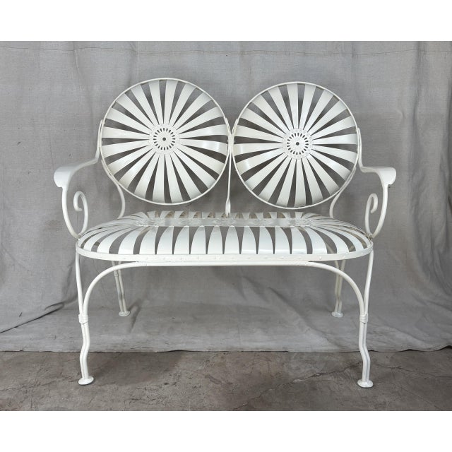 An early French sunburst garden bench, distinguished by the rare volute arm terminals found in the first generation of...