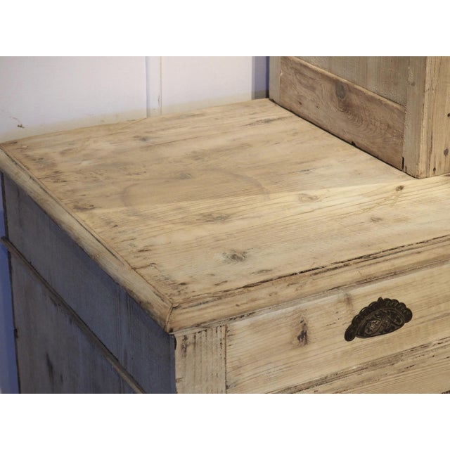 Hand-carved circa 1900, the original finish of this French bibliothèque has been scraped and stripped, leaving the pine...