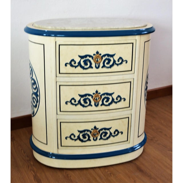 Dresser and bedside tables in a particular and unique style and shape, made entirely of white lacquered wood with blue...