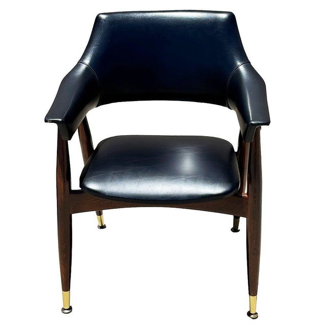 Mid-century accent chair fashion after the Paoli Chair and designers like Jordi Vilanova. It featuring a sculptural walnut...