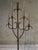 Our 20th century wrought iron candelabra stands just under 6ft tall.Dramatic and atmospheric, it rises from a quatreform...
