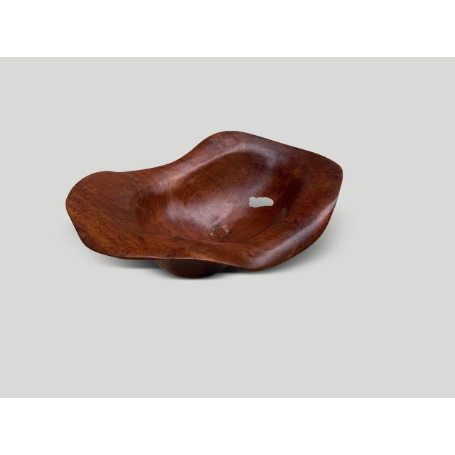 A beautiful sculptural bowl hand made from a single piece of century old teak wood with unique character. Both usable and...